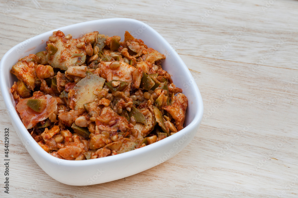 Achar made of green mango on rustic table with copy space Achar made of green mango on rustic table with copy space