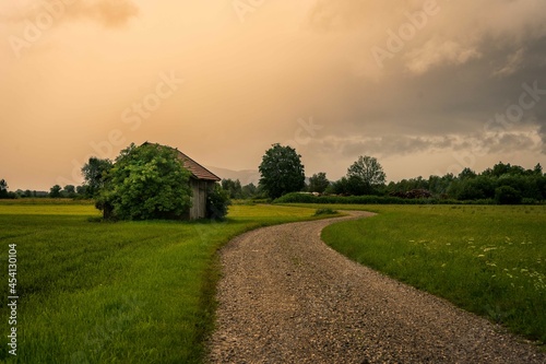 Meadow with path in the Allgäu before a thunderstorm