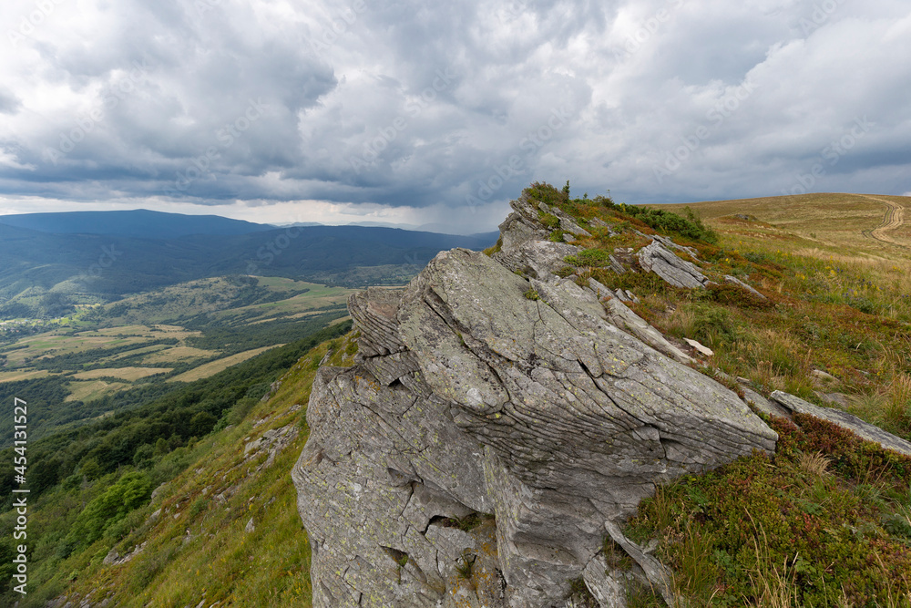 Fototapeta premium Verkhovyna Watershed Range, Pikui Mountain. Carpathian mountains with grassy slopes and rocks on Pikuy mount. Beautiful mountain landscape in summer