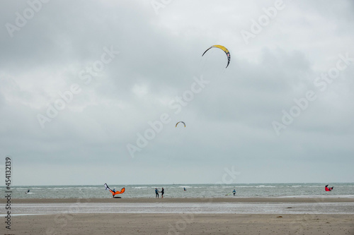 wind surfers on West Wittering beach West Sussex 
England on a stormy summer day