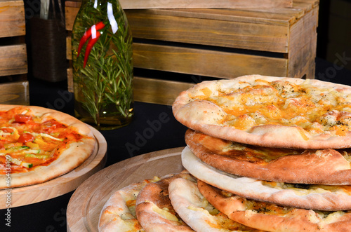 Fresh pizza with tomatoes, cheese and mushrooms on wooden table closeup