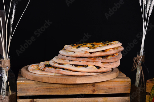 Fresh pizza with tomatoes, cheese and mushrooms on wooden table closeup