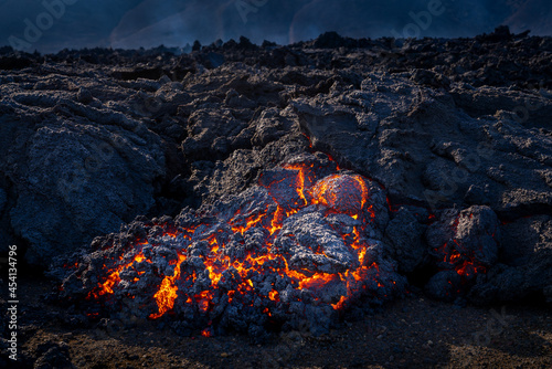 Looking at the lavaflow from the erupting volcanic crater of Geldingadalagos eruption in Reykjanes peninsula, Iceland. photo