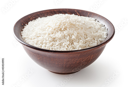 Uncooked jasmine rice in ceramic bowl isolated on white background