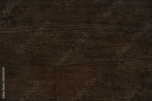 Old brown wood and crack pattern on surface for background and texture