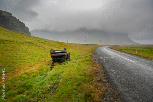 Car crash, upside down off the road.