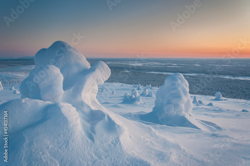 Title: snow-covered landscape with trees and mountains in Lapland, Finland in winter © Rauno