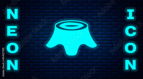 Glowing neon Tree stump icon isolated on brick wall background. Vector