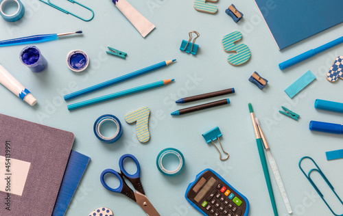 School supplies flat lay, stationery on blue background. Education, Back to School, kids creativity concept