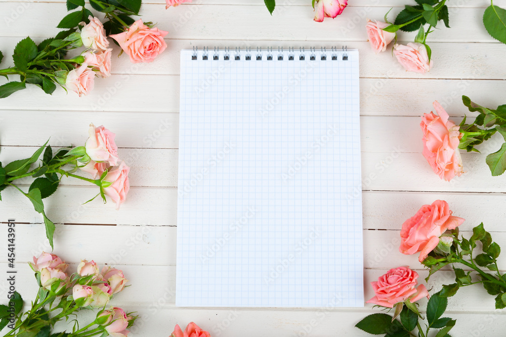Pink roses and paper for text Pink roses and paper for text