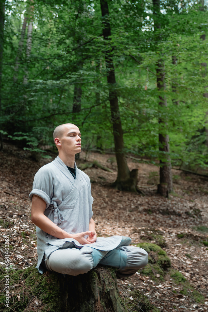 Warrior monk meditating in woodland