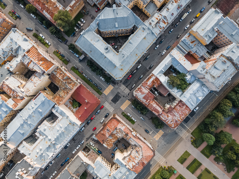 View from above on the crossroads and rusty rooftops of old living houses. Residential district in St Petersburg city center. Russia in the summer. Russian cities. Photo from the top.
