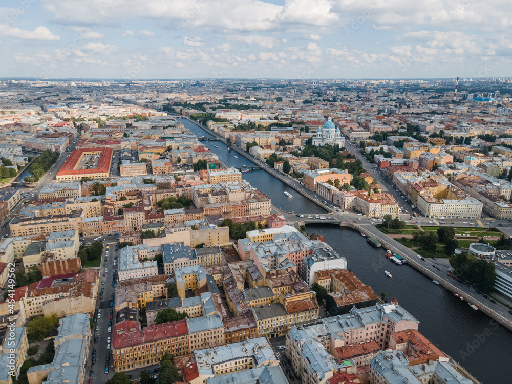 Obraz premium Aerial view of historical center of St Petersburg. Photo of Fontanka river, Trinity Cathedral, Nikolskie ryady and many old living houses. Cloudy blue sky. Russian cities. Place for vacation.