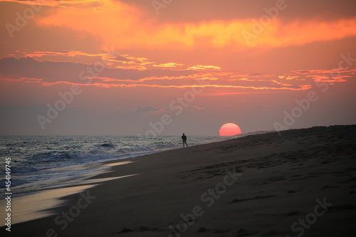 Fototapeta Naklejka Na Ścianę i Meble -  Children playing on the beach at sunset