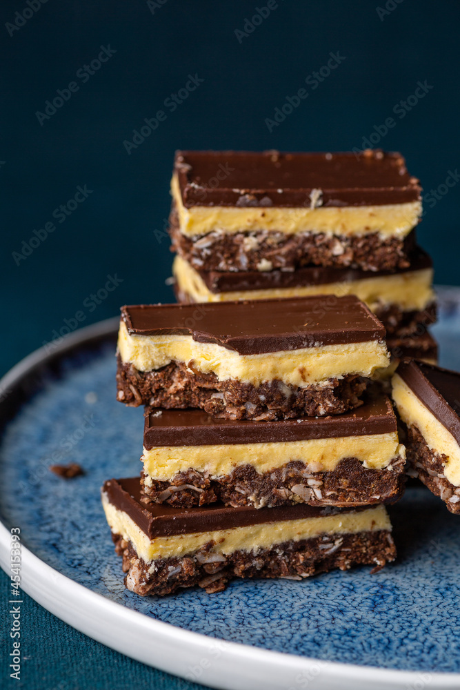 Nanaimo bars - a traditional Canadian dessert - on a dark background Nanaimo bars - a traditional Canadian dessert - on a dark background