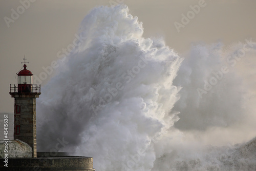 Fototapeta Naklejka Na Ścianę i Meble -  Stormy wave at old lighthouse