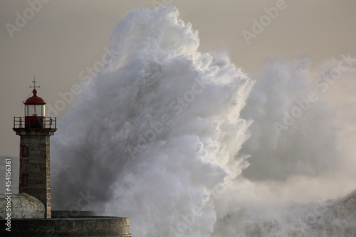 Stormy wave at old lighthouse