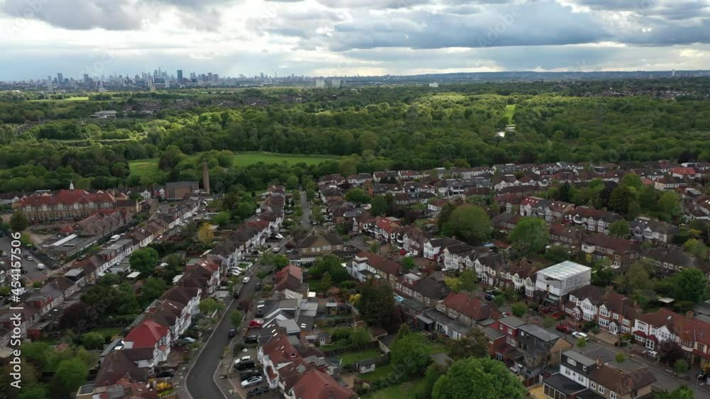 Rows of townhouses in city suburb, modern tall buildings in distance Rows of townhouses in city suburb, modern tall buildings in distance