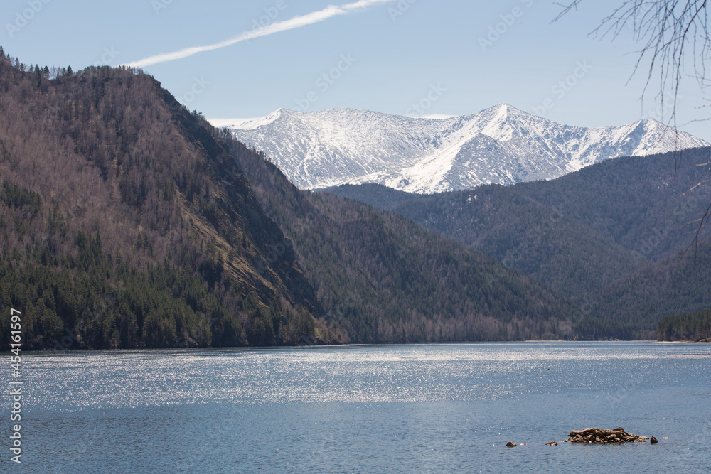 Atmospheric beautiful view of the Yenisei River, snowy mountains and forest on a clear day. Atmospheric beautiful view of the Yenisei River, snowy mountains and forest on a clear day.