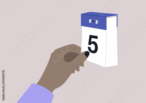 an isolated image of a tear-off calendar and a hand turning on the page, time concept