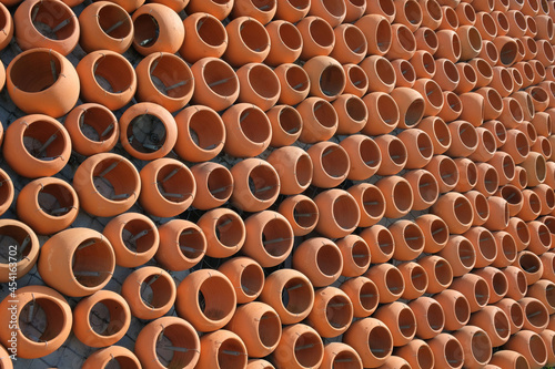 The wall made with rows of ceramic clay pots © Luka