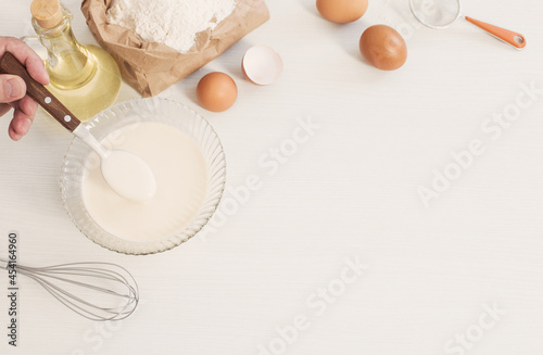 dough in glass plate and products for its preparation on white background