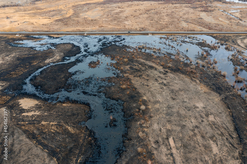 Oil spill near the highway. Environmental pollution