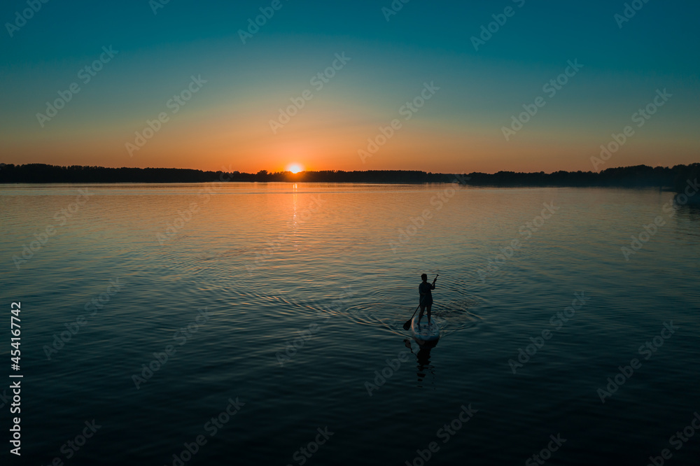 Woman silhouette on paddle board
