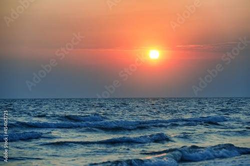 Picturesque sky with sun over sea at sunset
