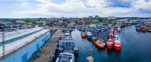 New Bedford harbor panorama aerial view with fishing boats docked at piers and historic downtown of New Bedford at the background, Massachusetts MA, USA.  photo