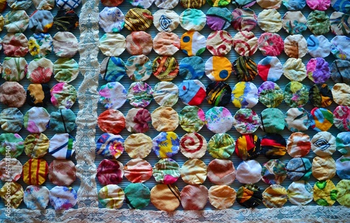 Fabric circles with lace forming a quilt © Fekete Images