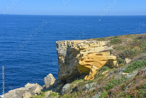 Colourful sandstone rock formations on the Cantabrian coastline. Mount Jaizkibel, Basque Country, Spain photo