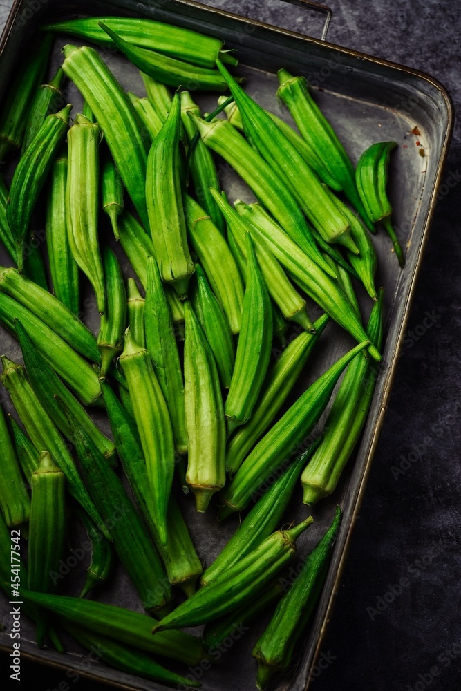 Fresh homegrown Okras places on rustic tray, top view Fresh homegrown Okras places on rustic tray, top view