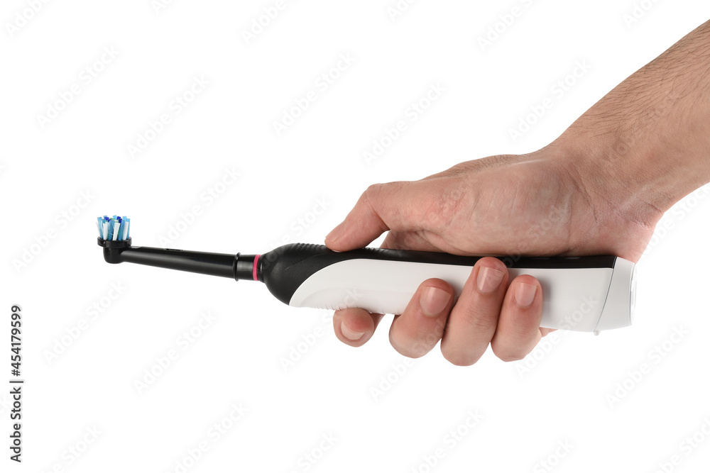Hand holding electric toothbrush on white background with clipping path Hand holding electric toothbrush on white background with clipping path