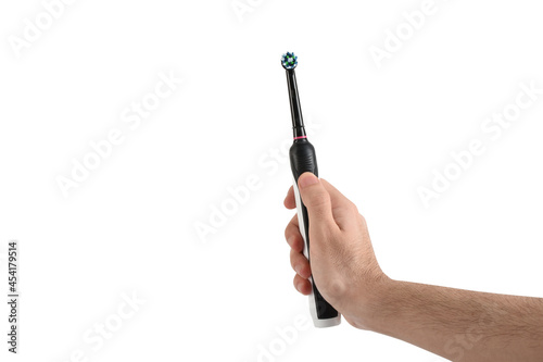 Hand holding electric toothbrush on white background with clipping path