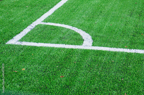 new soccer field, green turf and white dividing lines on the soccer field, corner and edge of the field, field markings photo