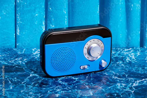 Blue radio receiver on table in studio