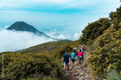 group of hikers in the mountains and izalco volcano at the background, el salvador photo
