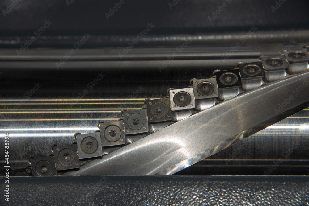 Thicknesser shaft with cutting knives. Woodworking machine Thicknesser shaft with cutting knives. Woodworking machine