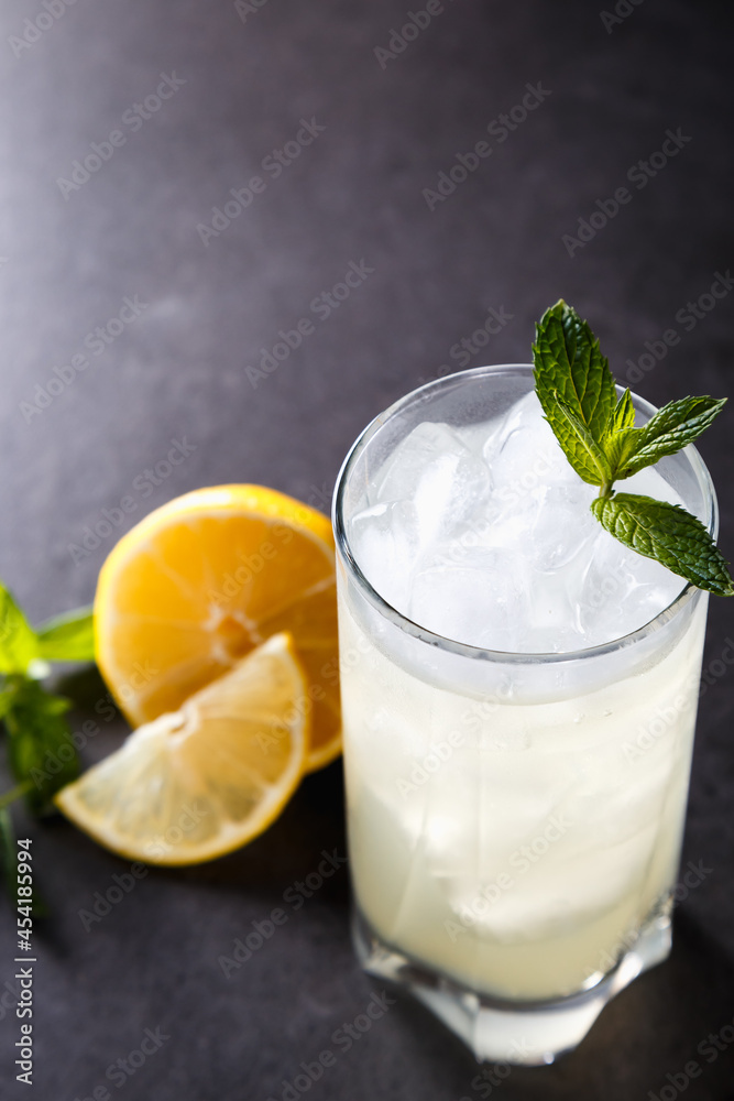 reshly squeezed lemonade with mint in a tall glass with ice. reshly squeezed lemonade with mint in a tall glass with ice.