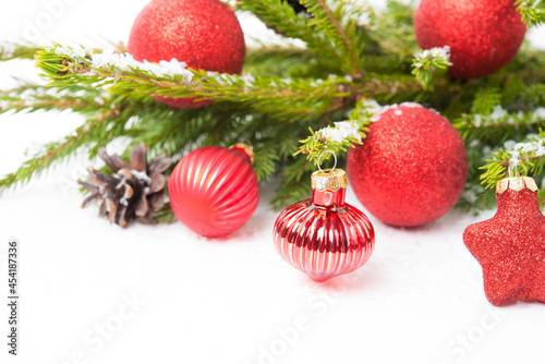 Christmas tree toys on a Christmas tree branch isolated on a white background, close-up