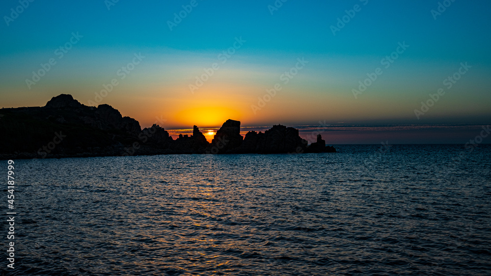 sunset view to the sea with coastline. Sardinia, Italy.