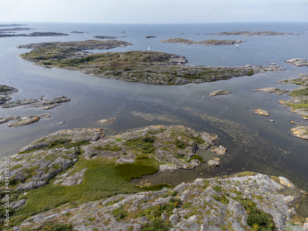Drone, aerial nature photography, seascape with cliffs, blue sky and sea in summertime in Sweden. Beautiful view of archipelago.