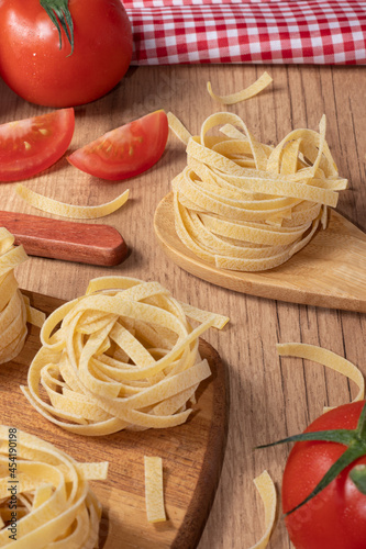 Red ripe tomatoes and spaghetti composition. Italian food theme.