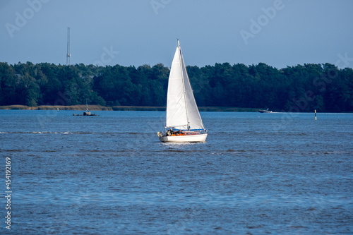 A small sailboat sailing across the horizon.