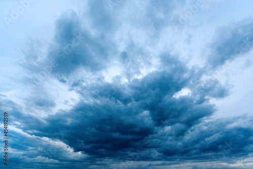 Dramatic stormy cumulus clouds at the sky in spring dusk