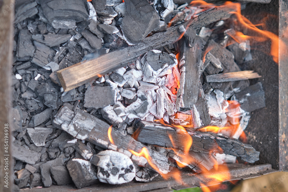 Close-Up Of Burning Coal On Metal Grill Close-Up Of Burning Coal On Metal Grill