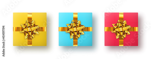 Three square shaped gift boxes with gold bows in the shape of a star. Top view. Vector clipart for decoration. Set of realistic gift presents in three colors isolated on white background.
