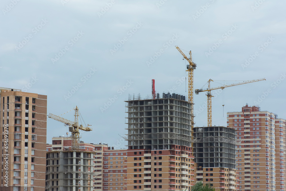 construction of high-rise buildings made of bricks and concrete using high-rise cranes