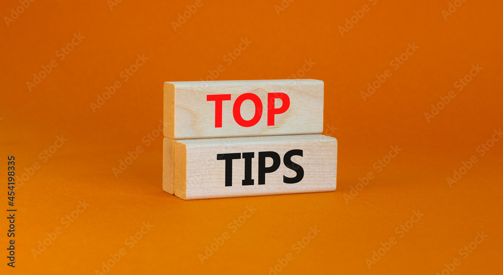 Top tips symbol. Concept words Top tips on wooden blocks on a beautiful orange background. Business and Top tips concept, copy space. Top tips symbol. Concept words Top tips on wooden blocks on a beautiful orange background. Business and Top tips concept, copy space.